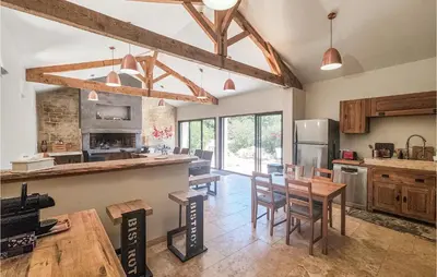 a kitchen with a table and chairs in a room at Cozy Home In Saint-Jean-De-Minervoi in Saint-Jean-de-Minervois