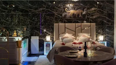 a bedroom with a bed and a table with wine glasses at Magnifique loft / spa en face de la cathédrale ! in Narbonne