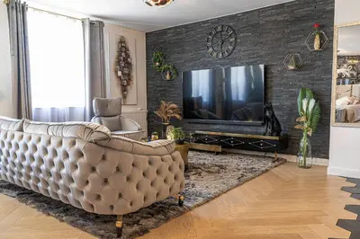 a living room with a couch and a tv at Magnifique loft / spa en face de la cathédrale ! in Narbonne