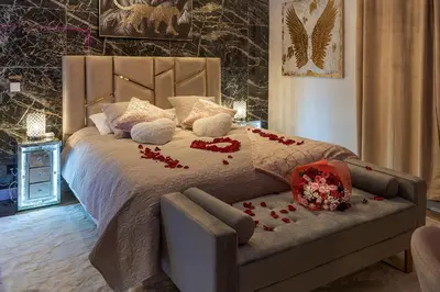 a bedroom with a bed with red roses on it at Magnifique loft / spa en face de la cathédrale ! in Narbonne