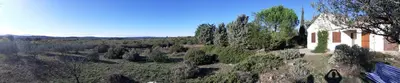 an aerial view of a house on a hill with trees at Les romarins in Saint-Jean-de-Minervois