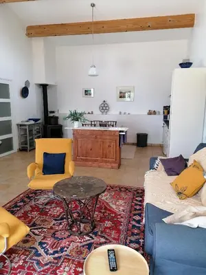 a living room with a couch and a table at Les romarins in Saint-Jean-de-Minervois