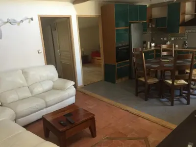 a living room with a white couch and a table at Cosy, calme et authentique au coeur de ville in Carcassonne