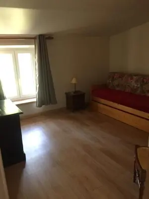 an empty room with a bed and a window at Cosy, calme et authentique au coeur de ville in Carcassonne