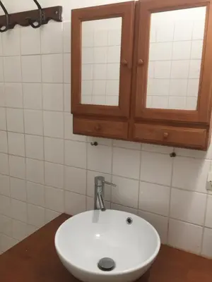 a bathroom with a sink and a medicine cabinet at Cosy, calme et authentique au coeur de ville in Carcassonne
