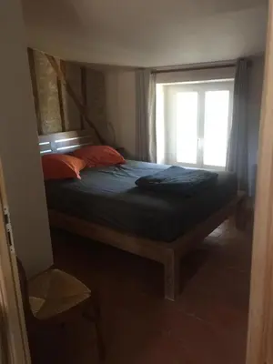 a bedroom with a bed with a window at Cosy, calme et authentique au coeur de ville in Carcassonne