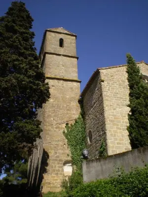 a tall brick building with a clock tower on it at Le cazal in Sainte-Eulalie