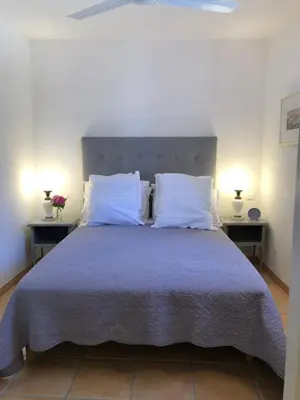 a bedroom with a large bed with two night stands at The Gatehouse in Castres