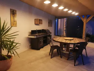 a kitchen with a table and a table and chairs at Maison L'Inattendu avec spa & piscine privatifs in Moussan