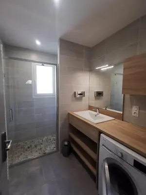 a bathroom with a sink and a washing machine at Maison L'Inattendu avec spa & piscine privatifs in Moussan