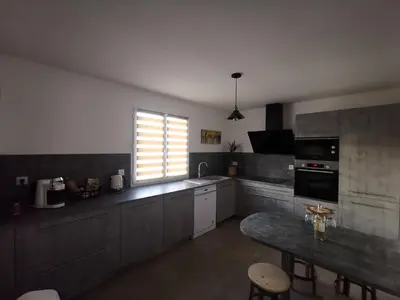 a large kitchen with a table and a window at Maison L'Inattendu avec spa & piscine privatifs in Moussan