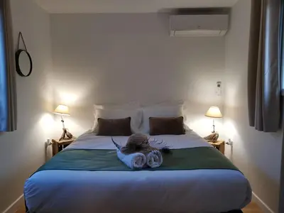 a woman laying on a bed in a bedroom at Maison L'Inattendu avec spa & piscine privatifs in Moussan