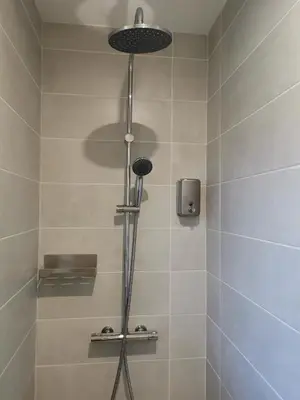 a shower with a shower head in a bathroom at Maison L'Inattendu avec spa & piscine privatifs in Moussan