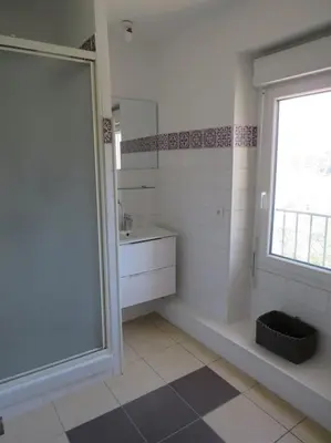 a bathroom with a shower and a sink and a window at Villa Ripaud Chambre d'Hôte in Villesèque-des-Corbières
