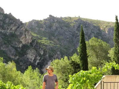 a man standing in front of a mountain at Villa Ripaud Chambre d'Hôte in Villesèque-des-Corbières