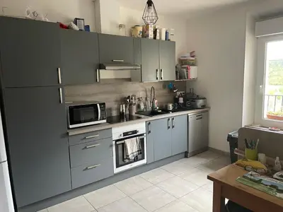 a kitchen with gray cabinets and a microwave at Villa Ripaud Chambre d'Hôte in Villesèque-des-Corbières