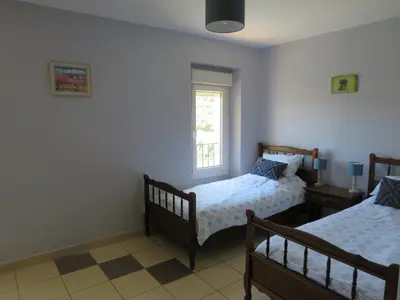 a bedroom with two beds and a window at Villa Ripaud Chambre d'Hôte in Villesèque-des-Corbières