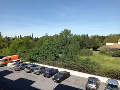 a row of cars parked in a parking lot at Studio Balcon Proche Hypercentre de Narbonne in Narbonne