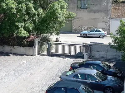 a couple of cars parked in a parking lot at Studio Balcon Proche Hypercentre de Narbonne in Narbonne