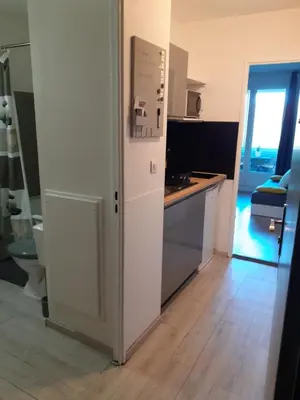 a kitchen with a white refrigerator and a sink at Studio Balcon Proche Hypercentre de Narbonne in Narbonne