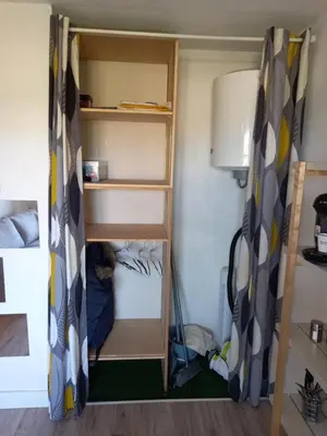 a small room with a bunk bed with shelves at Studio Balcon Proche Hypercentre de Narbonne in Narbonne