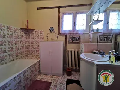 a bathroom with a tub and a sink and a bath tub at Le janabel in Prades-sur-Vernazobre