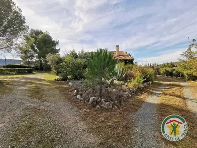 a house with a garden in front of a road at Le janabel in Prades-sur-Vernazobre
