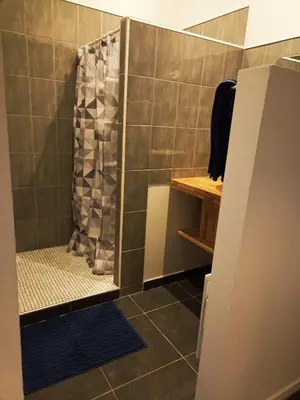 a shower with a shower curtain in a bathroom at Jolie Maison au centre du village in Gruissan