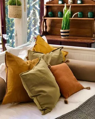 a pile of pillows sitting on a couch at Chez Luis et David in Avignonet-de-Lauragais