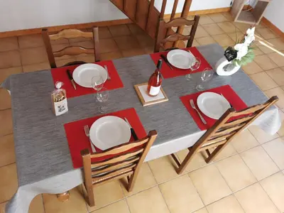 a dining table with red napkins and plates on it at Desix in Trilla