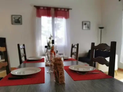 a wooden table with red napkins and plates on it at Desix in Trilla