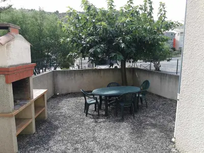 a table and chairs and a tree on a patio at Desix in Trilla
