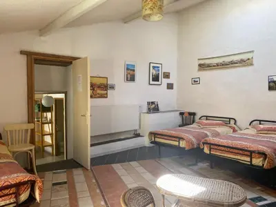 a room with three beds in a room at Gîte de la Bastide - Cabania Pays Cathare in Camps-sur-lʼAgly