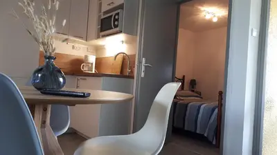 a small room with a table and a bed at la playa in Gruissan