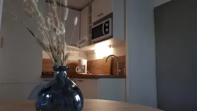 a blue vase sitting on a table in a kitchen at la playa in Gruissan