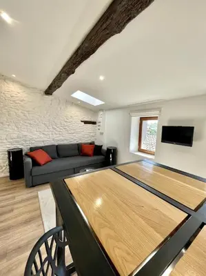 a living room with a table in the middle of a room at NEW, La Passante, Belle vue in Conques-sur-Orbiel