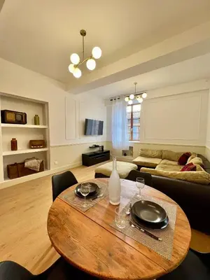a living room with a table and a couch at NEW, La Passante, Belle vue in Conques-sur-Orbiel