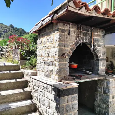 an outdoor brick oven with a pot in it at Villa Aimé in Caunes-Minervois