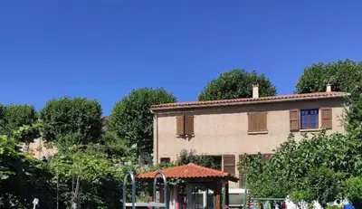 a building with a gazebo in front of it at Villa Aimé in Caunes-Minervois