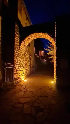 an archway in a building at night with lights at Mazamet : Résidence du Musée centre ville. in Mazamet