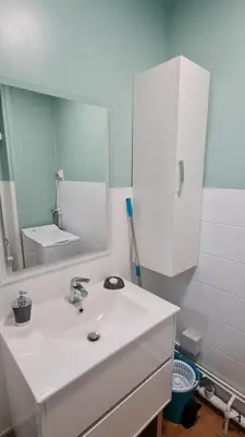 a bathroom with a white sink and a mirror at Mazamet : Résidence du Musée centre ville. in Mazamet