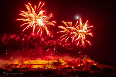 a fire show with fireworks in front of a castle at Le Marceau - Maison climatisée avec jardin in Carcassonne