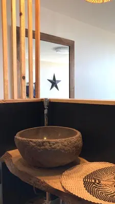 a bathroom with a bowl sink on a table at Panorama Suite & Spa in Carcassonne