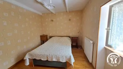 a small room with a bed and a window at Guyor in Le Bez