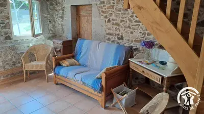 a room with a chair and a desk and a table at Guyor in Le Bez