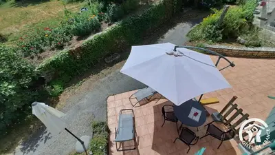 an overhead view of an umbrella and chairs on a patio at Guyor in Le Bez