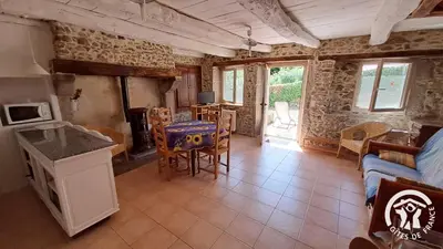 a kitchen and living room with a couch and a table at Guyor in Le Bez
