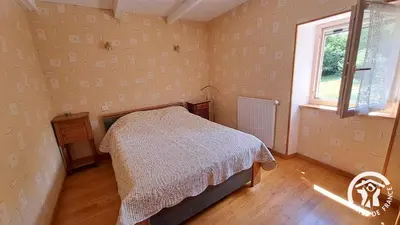 a bedroom with a bed and a window at Guyor in Le Bez