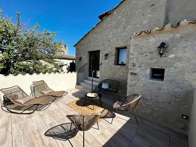 a patio with chairs and a building at Le Donjon de Lily - Cœur de La Cité Médiévale in Carcassonne