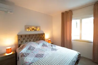 a bedroom with a bed with a quilt on it at Superbe appartement à 2 pas des Halles, Climatisé, terrasse, garage in Narbonne